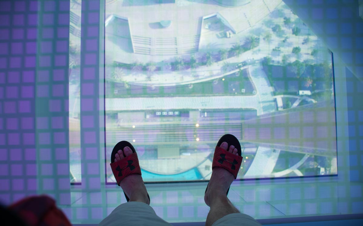 Tourist walking on Dubai Frame glass floor 150 meters high
