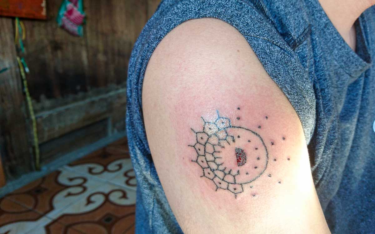 Sun and moon traditional tattoo design hand-tapped in Buscalan village