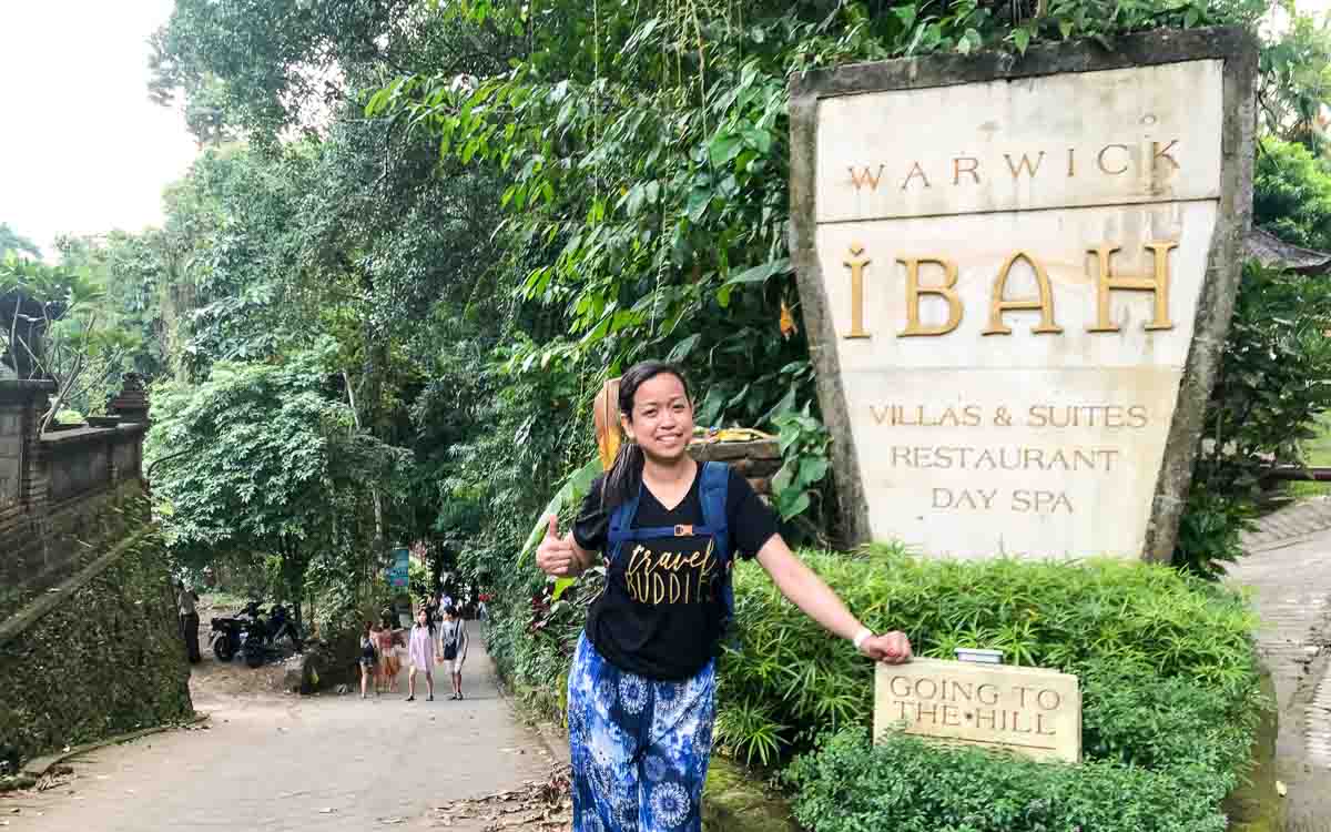 Official entrance signboard for Campuhan Ridge Walk hiking trail in Ubud, Bali with tropical vegetation surrounding the sign