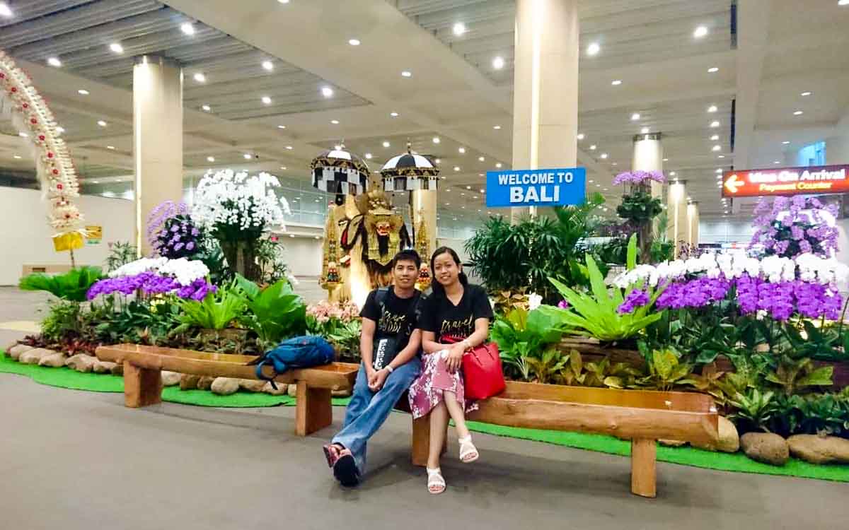 Couple arriving at Ngurah Rai International Airport Bali for romantic Ubud escape