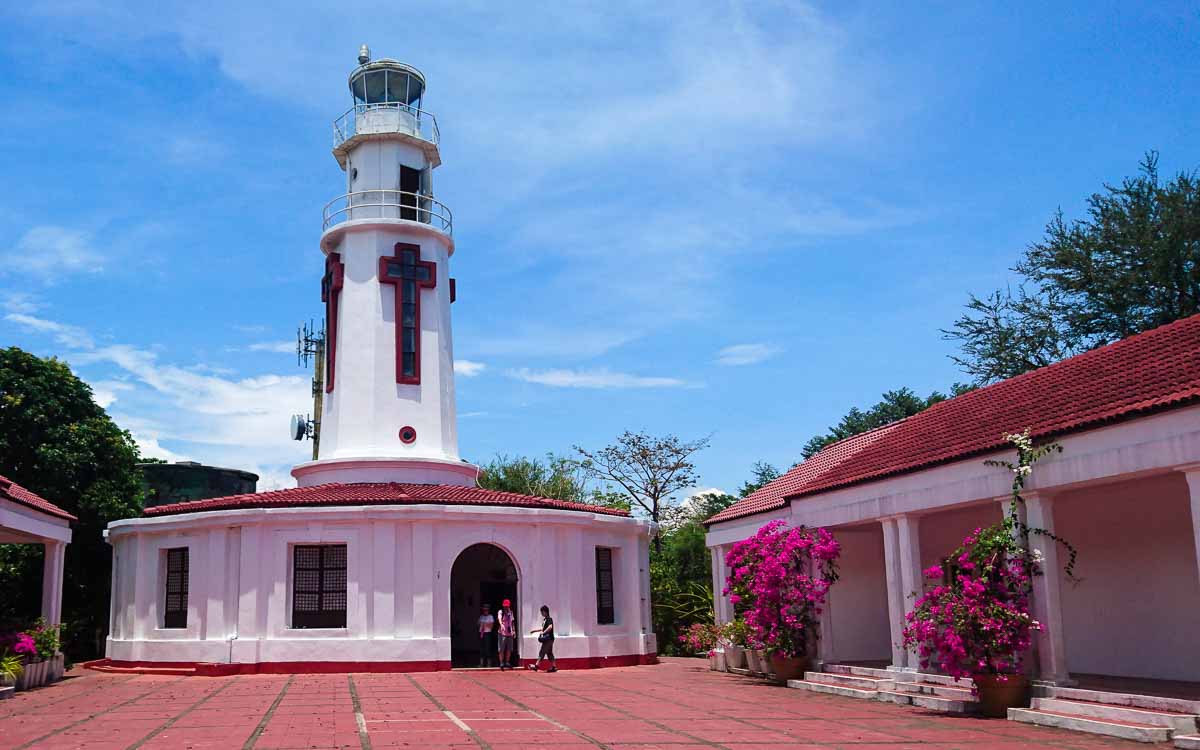 a white lighthouse with a cross shaped windows at Corregidor