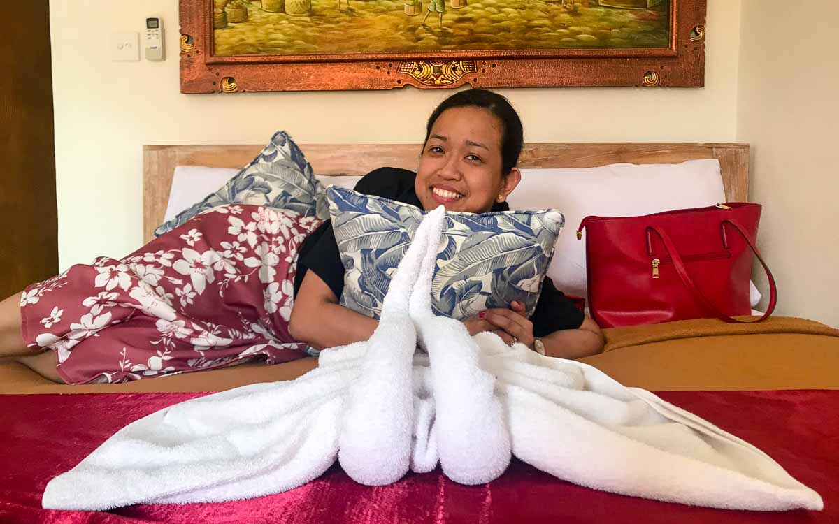 A woman relaxing on the bed at D'Ubud House in Ubud Bali