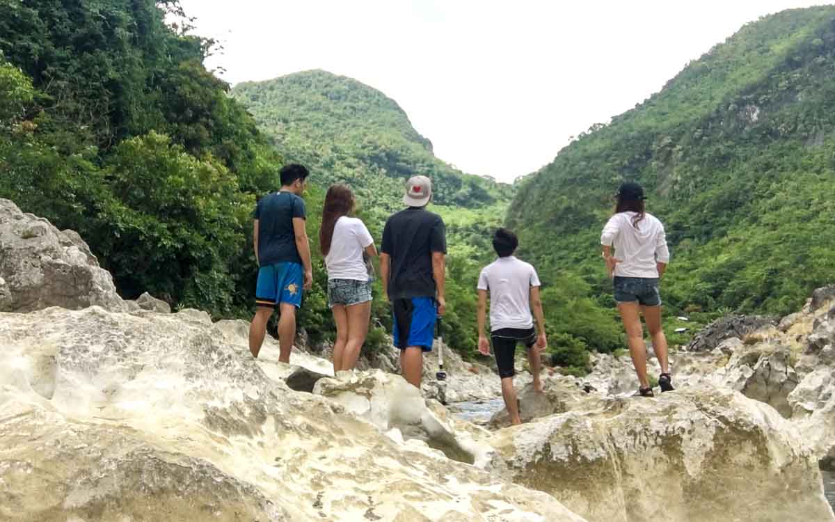 A group of people standing on rocks