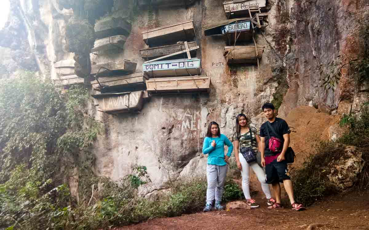 Hanah, Alex, and Nathaniel exploring the hanging coffins in Sagada