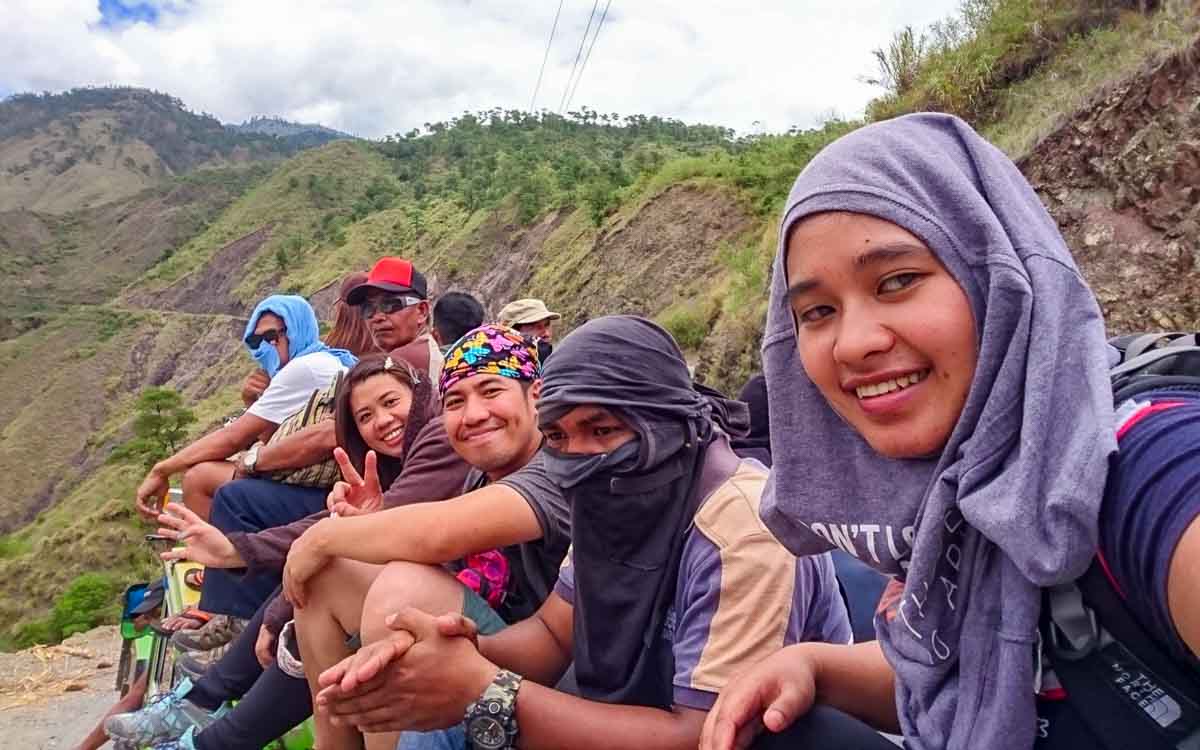 Travelers riding on the roof of a jeepney