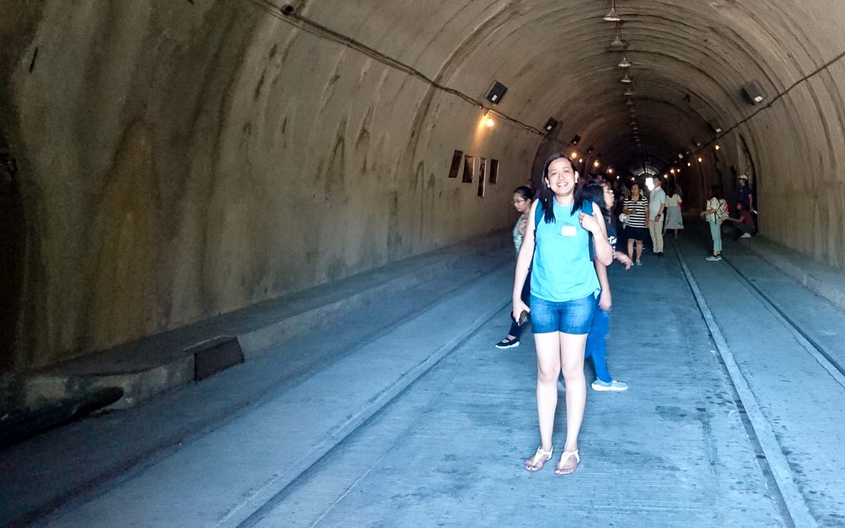 a group of people visiting inside the Malinta tunnel at Corregidor