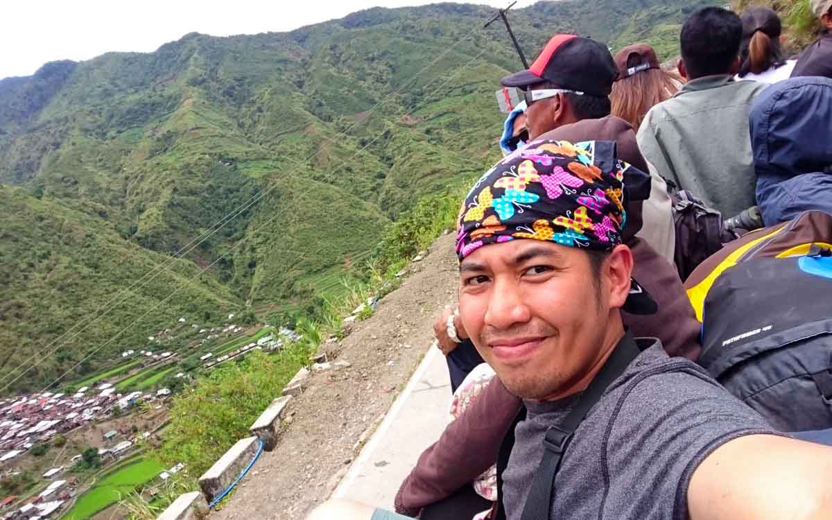 Passengers atop a jeepney roof during travel