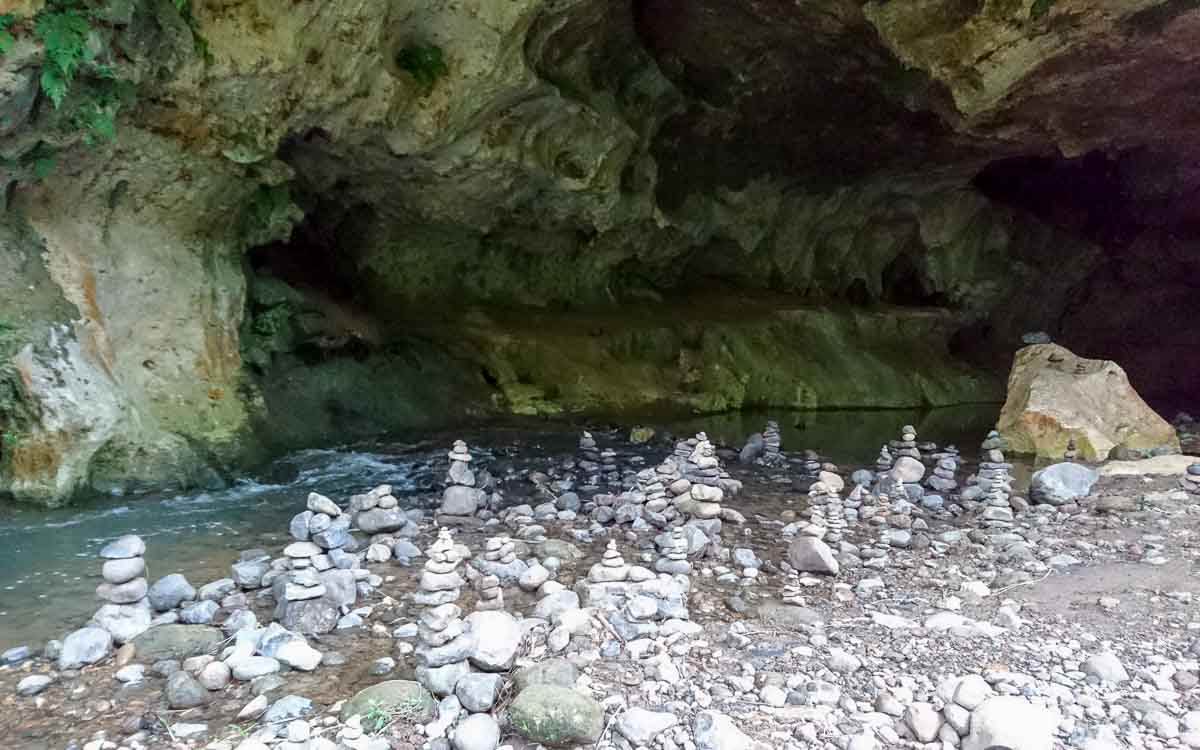 Stacked stones created by hikers at the entrance of the underground river cave