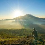 Spectacular sunrise view from Mount Batur summit overlooking Lake Batur and Mount Agung volcano in Bali