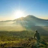 Spectacular sunrise view from Mount Batur summit overlooking Lake Batur and Mount Agung volcano in Bali
