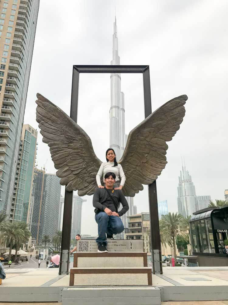 Wings of Mexico bronze statue at Burj Plaza Dubai with visitors taking photos