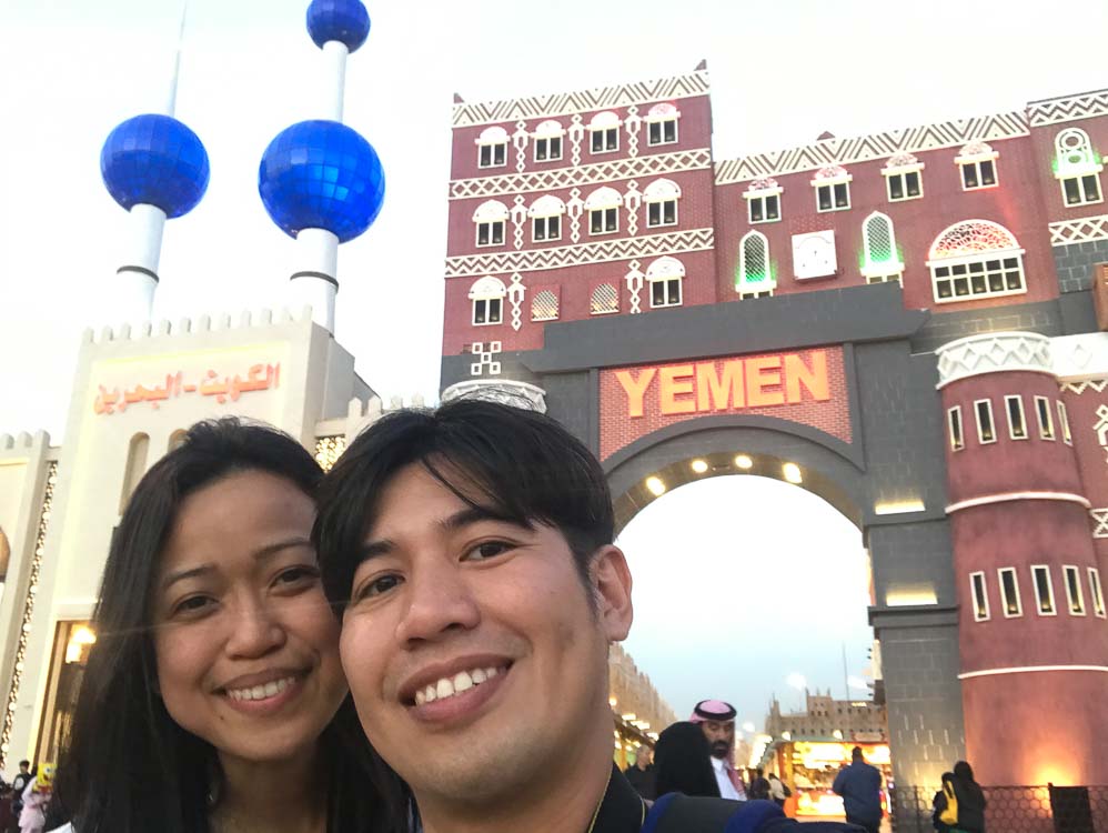 A couple standing in front of the Yemen pavilion.