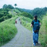 Tourists walking along Campuhan Ridge Walk in Ubud, Bali on a romantic getaway