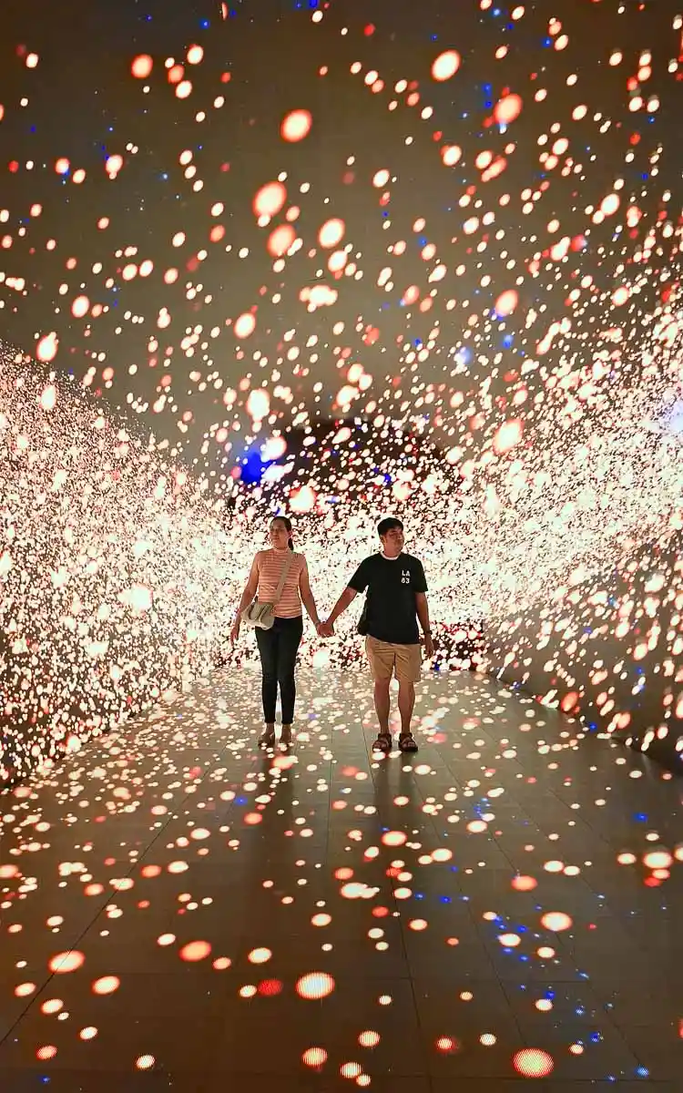 Husband and wife walking through the Time-Space Tunnel at Space & Time Cube SM North EDSA